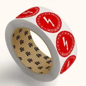 Elektrische keuringssticker op rol - rond - rood wit - symbool bliksemschicht met jaartallen 26-31 en maanden